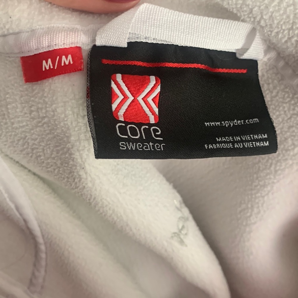 Women’s size medium Spyder full zip ribbed jacket in White. Never worn, no tags.